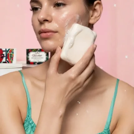 Model using Yuvraani Tan Clear Soap to gently cleanse skin, remove tan, and reveal a brighter, healthier complexion with a rich creamy lather.
