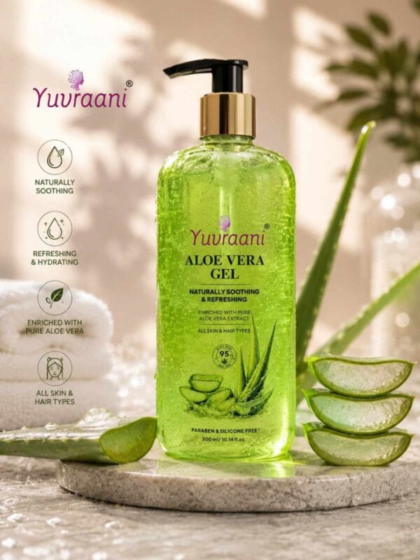 Yuvraani Aloe Vera Gel pump bottle with fresh aloe vera leaves resting on a minimalist concrete slab and sand backdrop